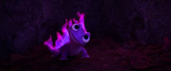 Movie still from “Frozen II” (2019), directed by Jennifer Lee – A toy lizard is lit up by a purple flame; Medium shot, Over the shoulder angle