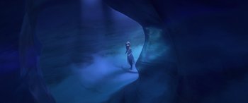 Movie still from “Frozen II” (2019), directed by Jennifer Lee – A woman standing in the middle of an underwater cave; Wide shot, High angle