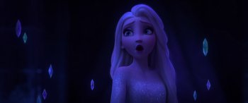 Movie still from “Frozen II” (2019), directed by Jennifer Lee – A woman with long white hair is looking surprised; Close Up shot, Over the shoulder angle