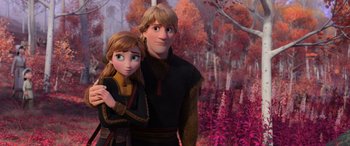 Movie still from “Frozen II” (2019), directed by Jennifer Lee – A man and a woman standing next to each other in a forest; Medium shot, Low angle