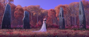 Movie still from “Frozen II” (2019), directed by Jennifer Lee – A woman in a long white dress standing in front of a tree; Wide shot, Low angle
