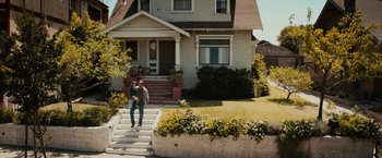 Movie still from “Furious 7” (2015), directed by James Wan – Two people walking down the steps of a house; Extreme Wide shot, Low angle