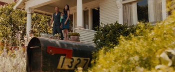 Movie still from “Furious 7” (2015), directed by James Wan – A man and a woman standing on the porch of a house; Wide shot, Low angle