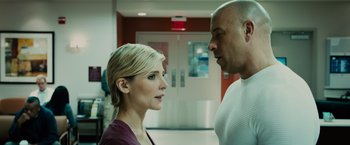 Movie still from “Furious 7” (2015), directed by James Wan – A man and a woman standing next to each other in a room; Close Up shot, Over the shoulder angle