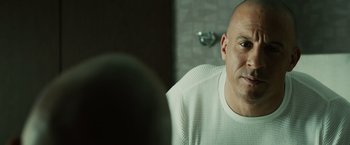 Movie still from “Furious 7” (2015), directed by James Wan – A bald man sitting in front of a bathroom mirror; Close Up shot, Over the shoulder angle