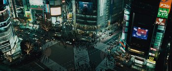 Movie still from “Furious 7” (2015), directed by James Wan – An aerial view of a busy city intersection at night; Extreme Wide shot, High angle