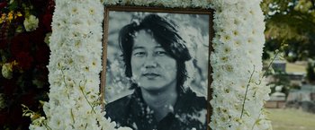 Movie still from “Furious 7” (2015), directed by James Wan – A black and white photo of a man with long hair; Close Up shot, High angle