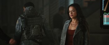 Movie still from “Furious 7” (2015), directed by James Wan – A woman standing next to a man in a military uniform; Medium shot, Over the shoulder angle