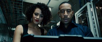 Movie still from “Furious 7” (2015), directed by James Wan – A man and a woman looking at a computer screen; Close Up shot, Low angle