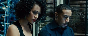 Movie still from “Furious 7” (2015), directed by James Wan – A man and a woman sitting next to each other in a room; Close Up shot, Low angle