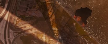 Movie still from “Furious 7” (2015), directed by James Wan – A man standing on a building looking down at the ground; Extreme Wide shot, Overhead angle