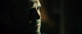 Movie still from “Furious 7” (2015), directed by James Wan – A man's face in the dark; Close Up shot, Over the shoulder angle