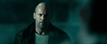 Movie still from “Furious 7” (2015), directed by James Wan – A man with a bald head is looking at the camera; Close Up shot, Low angle