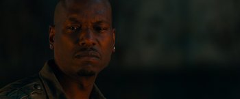 Movie still from “Furious 7” (2015), directed by James Wan – A person with a piercing on his ear; Close Up shot, Low angle