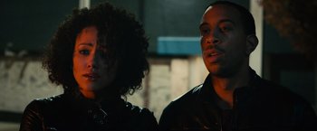 Movie still from “Furious 7” (2015), directed by James Wan – A man and a woman standing next to each other; Close Up shot, Low angle