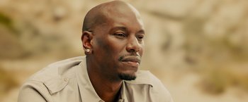 Movie still from “Furious 7” (2015), directed by James Wan – A person wearing a shirt; Close Up shot, High angle