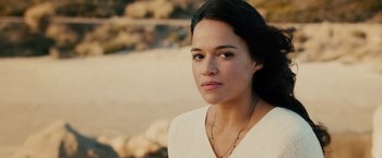 Movie still from “Furious 7” (2015), directed by James Wan – A person wearing a white shirt; Close Up shot, Over the shoulder angle