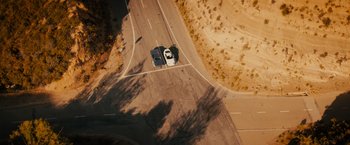 Movie still from “Furious 7” (2015), directed by James Wan – An aerial view of a car on the road; Extreme Wide shot, Overhead angle