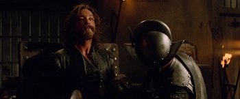 Movie still from “G.I. Joe: The Rise of Cobra” (2009), directed by Stephen Sommers – A man with long hair and a beard wearing a leather jacket; Medium shot, Low angle