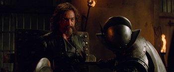 Movie still from “G.I. Joe: The Rise of Cobra” (2009), directed by Stephen Sommers – A man with long hair and a beard holding a sword; Medium shot, Over the shoulder angle