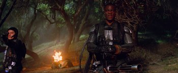 Movie still from “G.I. Joe: The Rise of Cobra” (2009), directed by Stephen Sommers – A man sitting next to a fire in the woods; Medium shot, Low angle