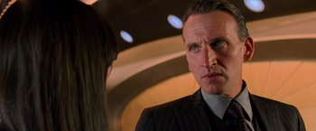 Movie still from “G.I. Joe: The Rise of Cobra” (2009), directed by Stephen Sommers – A person wearing a suit and tie; Close Up shot, Over the shoulder angle