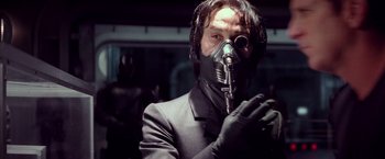 Movie still from “G.I. Joe: The Rise of Cobra” (2009), directed by Stephen Sommers – A man in a suit and a gas mask; Close Up shot, Low angle