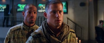 Movie still from “G.I. Joe: The Rise of Cobra” (2009), directed by Stephen Sommers – A man in a military uniform with a scarf around his neck; Close Up shot, Over the shoulder angle