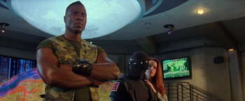 Movie still from “G.I. Joe: The Rise of Cobra” (2009), directed by Stephen Sommers – A group of people standing next to each other in a room; Medium shot, Low angle
