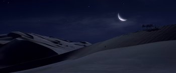 Movie still from “G.I. Joe: The Rise of Cobra” (2009), directed by Stephen Sommers – A night sky with a crescent moon and stars over a snow covered hill; Extreme Wide shot, High angle