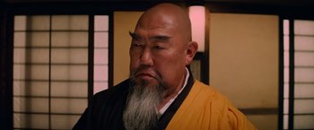 Movie still from “G.I. Joe: The Rise of Cobra” (2009), directed by Stephen Sommers – An older bald man with a long beard; Close Up shot, Low angle