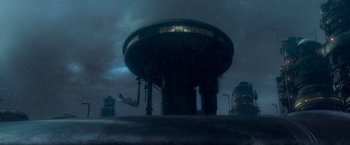 Movie still from “G.I. Joe: The Rise of Cobra” (2009), directed by Stephen Sommers – A dark picture of an industrial area with a water tower in the background; Extreme Wide shot, Low angle