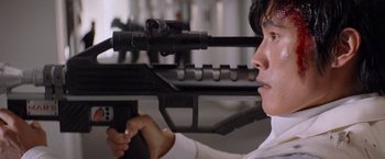 Movie still from “G.I. Joe: The Rise of Cobra” (2009), directed by Stephen Sommers – A man is holding a gun in his hand; Close Up shot, Low angle
