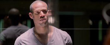 Movie still from “G.I. Joe: The Rise of Cobra” (2009), directed by Stephen Sommers – A person wearing a gray t - shirt; Close Up shot, Low angle