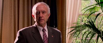 Movie still from “G.I. Joe: The Rise of Cobra” (2009), directed by Stephen Sommers – An older man wearing a suit and tie; Close Up shot, Low angle