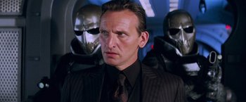 Movie still from “G.I. Joe: The Rise of Cobra” (2009), directed by Stephen Sommers – A person wearing a suit and tie; Close Up shot, Over the shoulder angle