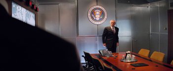 Movie still from “G.I. Joe: The Rise of Cobra” (2009), directed by Stephen Sommers – A man standing in front of a conference room table; Wide shot, Over the shoulder angle
