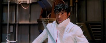 Movie still from “G.I. Joe: The Rise of Cobra” (2009), directed by Stephen Sommers – A man in white shirt holding a sword in a room; Close Up shot, Low angle