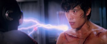 Movie still from “G.I. Joe: The Rise of Cobra” (2009), directed by Stephen Sommers – A young man with a scar on his face and a lightning strike behind him; Close Up shot, Low angle