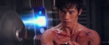 Movie still from “G.I. Joe: The Rise of Cobra” (2009), directed by Stephen Sommers – A man with a scar on his arm and chest; Close Up shot, Over the shoulder angle