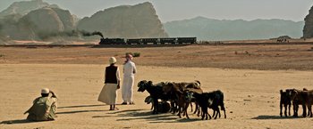 Movie still from “All the Money in the World” (2017), directed by Ridley Scott – Two people and a herd of animals in the desert; Extreme Wide shot, Low angle
