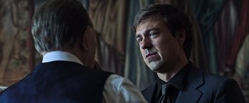 Movie still from “All the Money in the World” (2017), directed by Ridley Scott – A man wearing a suit and tie talking to another man wearing a suit and tie; Close Up shot, Over the shoulder angle