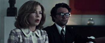 Movie still from “All the Money in the World” (2017), directed by Ridley Scott – A man and a woman are standing next to each other; Close Up shot, Low angle