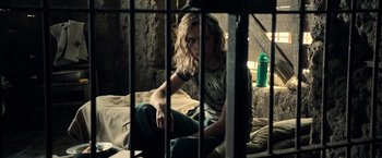 Movie still from “All the Money in the World” (2017), directed by Ridley Scott – A man sitting on a bed in a jail cell; Medium shot, High angle