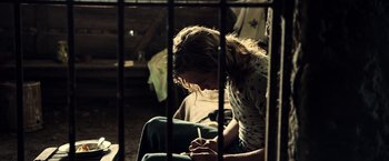 Movie still from “All the Money in the World” (2017), directed by Ridley Scott – A person sitting in a room with a cell phone; Medium shot, High angle