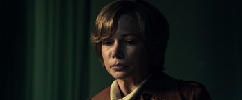 Movie still from “All the Money in the World” (2017), directed by Ridley Scott – A person with short hair; Close Up shot, Over the shoulder angle