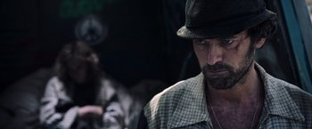 Movie still from “All the Money in the World” (2017), directed by Ridley Scott – A person wearing a hat; Close Up shot, Over the shoulder angle