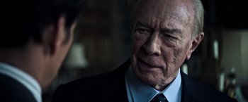 Movie still from “All the Money in the World” (2017), directed by Ridley Scott – An older man wearing a suit and tie; Close Up shot, Over the shoulder angle
