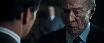 Movie still from “All the Money in the World” (2017), directed by Ridley Scott – An older man in a suit and tie looking at a younger man; Close Up shot, Over the shoulder angle