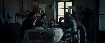 Movie still from “All the Money in the World” (2017), directed by Ridley Scott – A group of people sitting at a table eating; Wide shot, Low angle